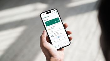 A person holding the phone with the Smart Rent App open at Bavarian Village Apartments, Indianapolis, 46235